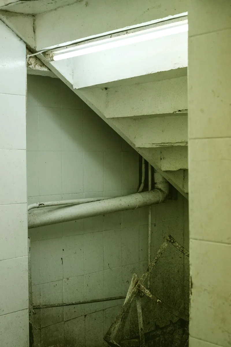 Basement block wall and stairwell being checked for cracks and movement
