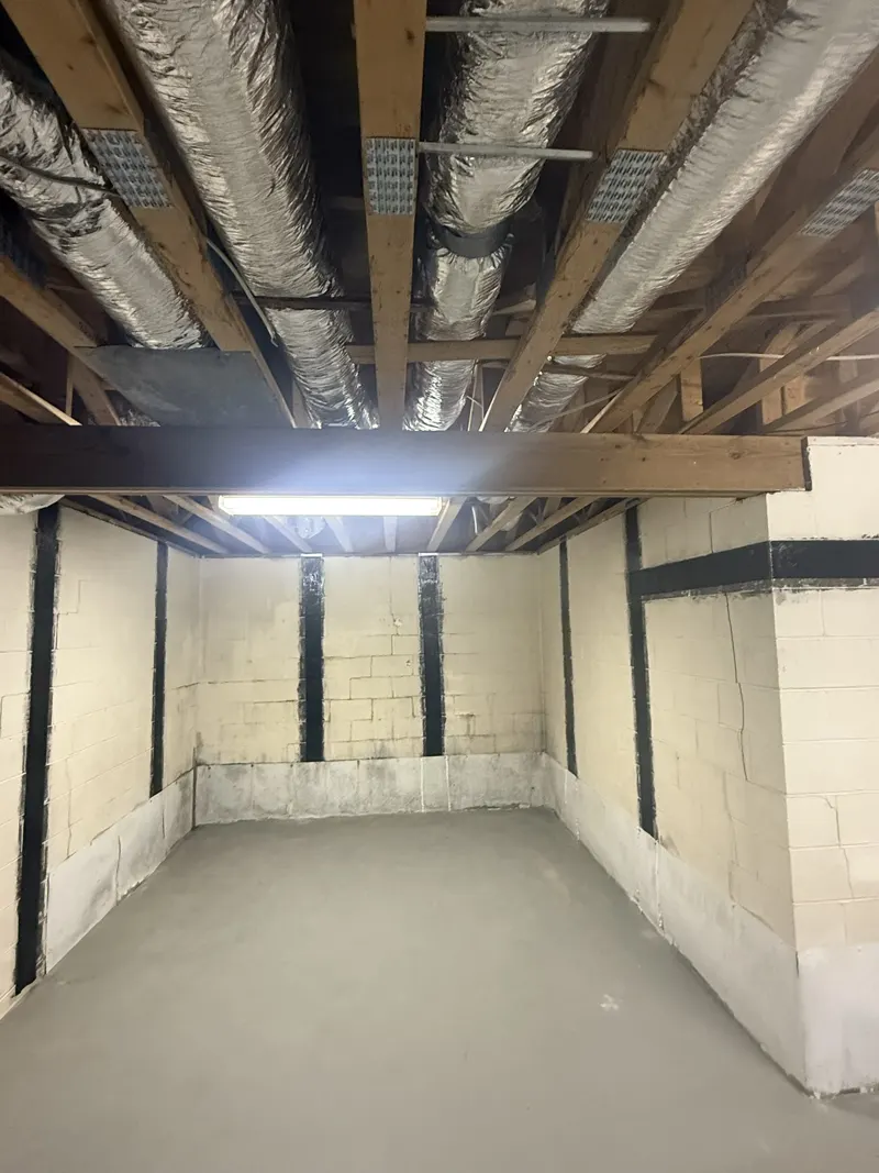 Basement room with evenly spaced carbon fiber straps on the block walls