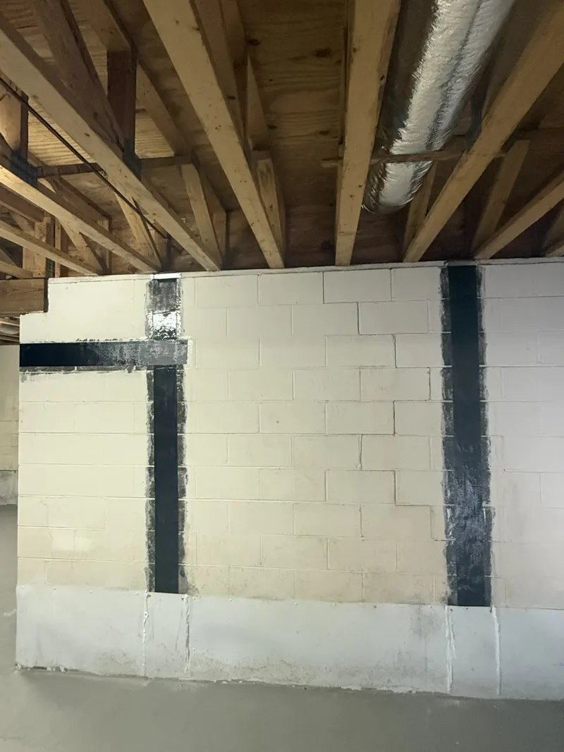 Carbon fiber straps and a horizontal strap on a block foundation wall under the floor framing